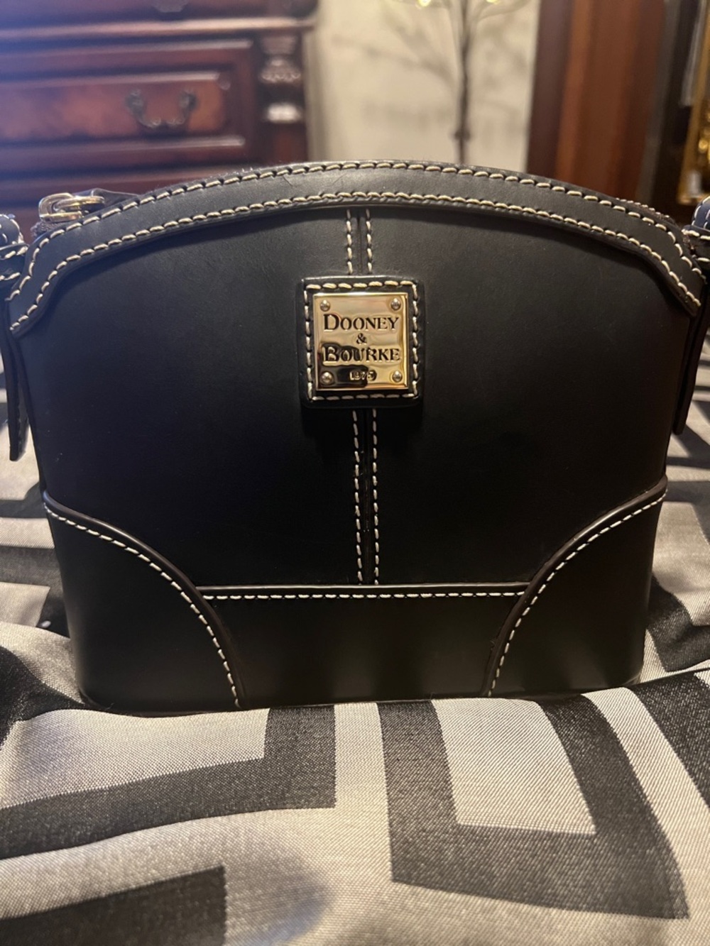 Dooney & Bourke Black Leather Crossbody with White Stitching and Gold Plaque